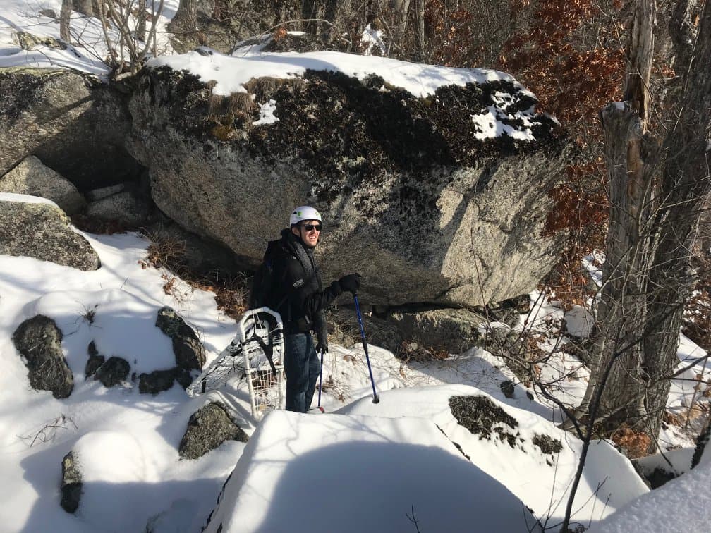 Nick hiking in the wintery woods of Maine